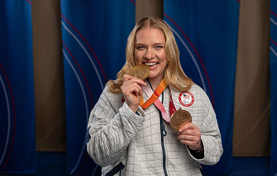 Rose Hollermann holding 2 olympic medals